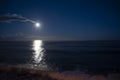 Moonlight path on water of Atlantic ocean at night on Tenerife and dark blue sky with full Moon and stars Royalty Free Stock Photo