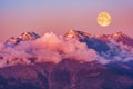 Moonrise above Caucasus mountains at evening time.