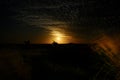 Moonrise on the coast with starts and scattered clouds Royalty Free Stock Photo