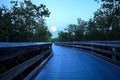 Moonrise over boardwalk over River leading to the ocean at Royalty Free Stock Photo