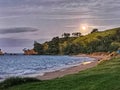 A moonrise over a Pacific ocean beach in New Zealand Royalty Free Stock Photo