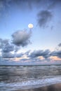 Moonset over the ocean at Vanderbilt Beach at sunset Royalty Free Stock Photo