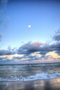 Moonset over the ocean at Vanderbilt Beach at sunset Royalty Free Stock Photo