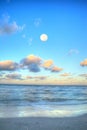 Moonset over the ocean at Vanderbilt Beach at sunset Royalty Free Stock Photo