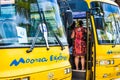 Moorea, French Polynesia: 09/03/2018: A local woman waiting next to the bus to show the tropical island to the tourists. Paradise