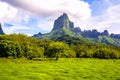 Moorea, French Polynesia: 09/03/2018: Total lanscape of the colorful main mountain in Moorea, everywhere is green and a blue sky Royalty Free Stock Photo