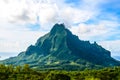 Moorea, French Polynesia: 09/03/2018: Total lanscape of the colorful main mountain in Moorea, everywhere is green and a blue sky Royalty Free Stock Photo