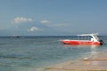 A moored boat and, in the background, Mount Agung in Bali. Toya Pakeh. Nusa Penida. Bali province. Indonesia