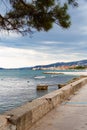 Moored boat. Embankment in Croatia, Kastel Luksic. View of the Adriatic Sea and mountains. In the background is the city of Trogir