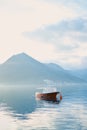 Moored boat in the sea against the backdrop of mountains in the fog in the evening Royalty Free Stock Photo