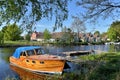 Moored boat and small wooden houses along the river Royalty Free Stock Photo