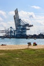 Moored boats, beach and cranes of the Freeport