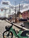 Moored boats in Nyhavn, Copenhagen, Denmark with a modern electric bicycle parked Royalty Free Stock Photo