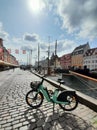 Moored boats in Nyhavn, Copenhagen, Denmark and modern electric bicycle Bolt parked nearby Royalty Free Stock Photo