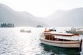 Moored excursion boats and motorboats at sea against the backdrop of the islands of the Bay of Kotor. Perast, Montenegro Royalty Free Stock Photo