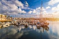 Moored fishing boats in the harbor at sunset with flying seagulls over the boats, Lagos, The Algarve, Portugal. Yachts moored in Royalty Free Stock Photo