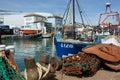 Moored Fishing boats at the quayside. Nets & dredging chains Royalty Free Stock Photo