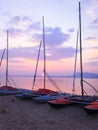 Moored sailboats near the shore at sunset