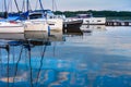 Moored sailboats on a pier calm early morning