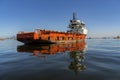 Moored ship. Red boat moored in the calm sea of a bay. Royalty Free Stock Photo