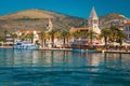 Moored ships and waterfront promenade with palms in Trogir, Croatia Royalty Free Stock Photo