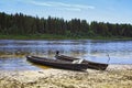 Unusual elongated wooden boats of the Mansi people in Siberia Royalty Free Stock Photo