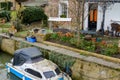 Moored-up, private boat seen by a private residence in England. Royalty Free Stock Photo