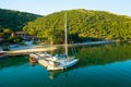 Moored yachts near oyster farm surrounded by mountains Royalty Free Stock Photo