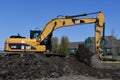 Caterpillar 319D excavator machine moving earth