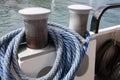 Mooring bollard with blue used rope on it Royalty Free Stock Photo