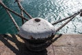 Mooring bollard on the dock with ropes on it Royalty Free Stock Photo
