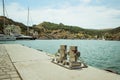 Mooring bollard, intertwined with mooring rope at the port in the Bay