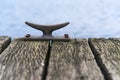 Mooring bollard of metal on a wooden pier bridge at the sea, cop Royalty Free Stock Photo