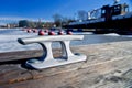 Mooring bollard of metal on a wooden pier Royalty Free Stock Photo