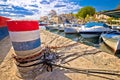 Mooring bollard and old boats in Kastela harbor