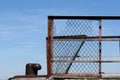 Mooring bollard and rusty metal mesh on blue sky background Royalty Free Stock Photo