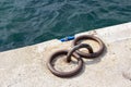 Mooring bollards on the quay of the sea. Rusty mooring bollard on the dock of the sea