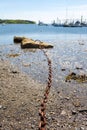 Mooring chain for boat leading to rock