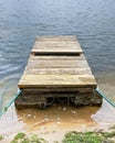 The mooring for fishing boats is made of two rusty pontoons and Royalty Free Stock Photo