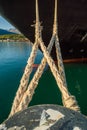 Bow and mooring lines of cruise ship tied to dock bollard,, Alaska. Royalty Free Stock Photo