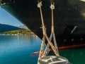 Bow, rat guards and mooring lines of cruise ship tied to dock bollard,, Alaska. Royalty Free Stock Photo