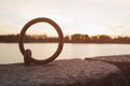 Mooring ring on river bank for boats in sunset Royalty Free Stock Photo