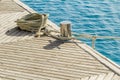 Mooring rope and bollard on sea water and yachts background. Royalty Free Stock Photo