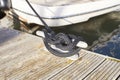 Mooring rope and bollard on sea water and yachts background