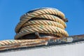 Mooring rope coiled around a bollard at a steel ship