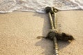 Mooring rope with knots on fine sand