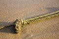 Mooring rope with knots on fine sand