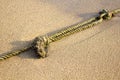 Mooring rope with knots on fine sand