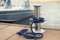 mooring rope on a metal bollard on a boat background Royalty Free Stock Photo
