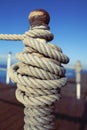 Mooring rope tied to a bollard on the dock Royalty Free Stock Photo